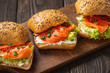 Sandwiches with salmon, lettuce and rye bread.