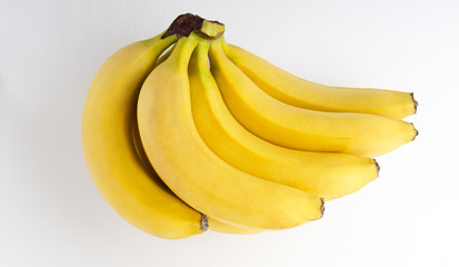 Top view and closeup of ripe yellow bunch of banans on the white background