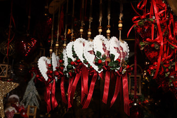 Wall Mural - Christmas tree ornament decoration red ribbons and cute little angels for hanging in the tree