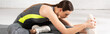 panoramic orientation of young and attractive sportswoman warming up on fitness mat
