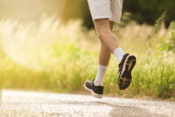 Detail of man running free in nature. Ideal to express the concept of vitality and healthy life. Copy space.