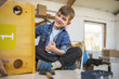 Young boy using a hammer while assembling bird house