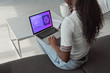 © LIGHTFIELD STUDIOS - high angle view of african american girl using laptop with best shopping website on screen