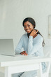 © LIGHTFIELD STUDIOS - happy african american freelancer smiling at camera while sitting near laptop at home