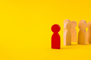 Faceless wooden figures of people gathering community following their leader inspiring experience isolated over bright vivid shine vibrant yellow color background