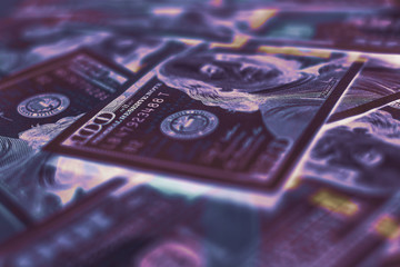 Aufkleber - Close-up of US dollar bills in neon blue and purple lighting, featuring a shallow depth of field and a futuristic aesthetic.