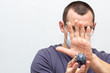 © dashtik - Man in medical mask holds grey model of virus in his hands