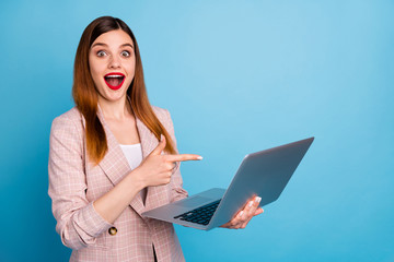 Sticker - Portrait of excited shocked girl manager work home laptop point index finger screen impressed social media promotion wear plaid jacket isolated over blue color background