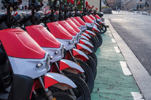 Electric Motorcycles For Rent In The City Center. Clean Transportation, Red Motorcycles.