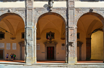 Sticker - Detail of main square with arches of City Hall building in old historic alley in the medieval village of Sansepolcro near city of Arezzo in Tuscany, 