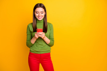 Wall Mural - portrait of positive cheerful girl using smartphone reading social media news share posts comments w