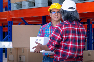 Delivery man delivers the goods to the warehouse manager at warehouse, delivery service concept