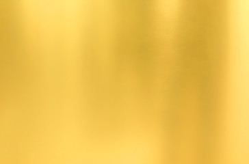 gold wall texture background. yellow shiny gold metal sheet surface with light reflection