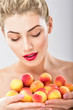 © Svetlana Fedoseeva - Beautiful woman holding a juicy apricots. Perfect skin. Professional makeup.