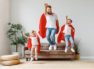 Joyful father and children having fun at home.