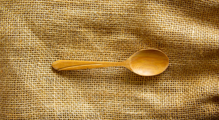 Wall Mural - Beautiful wooden spoon isolated on canvas background. Concept.