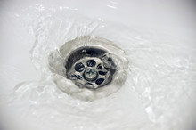 Water Flow Into Drain In White Bath