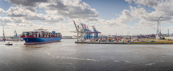 Wall Mural - Panorama of a container terminal with arriving container ship and tug in Hamburg 