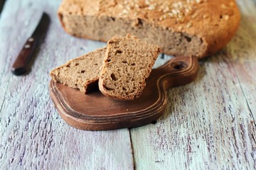 Homemade bread sliced in slices on a wooden board, healthy food, whole grain, organic product