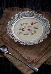 Wall Mural - Kheer or Payasam is a type of rice pudding from the Indian subcontinent, made by boiling milk and sugar and is flavoured with dry fruits and nuts, served in decorative plate.