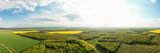 Fototapeta  - Scenic landscape of countryside from bird's eye view, springtime. Aerial drone view of woodland and farmland