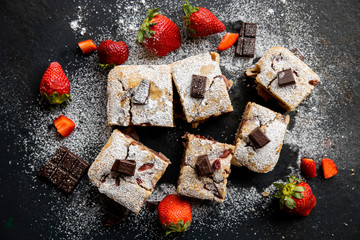 Selective focus. Strawberry chocolate cake on a dark background with fresh strawberries