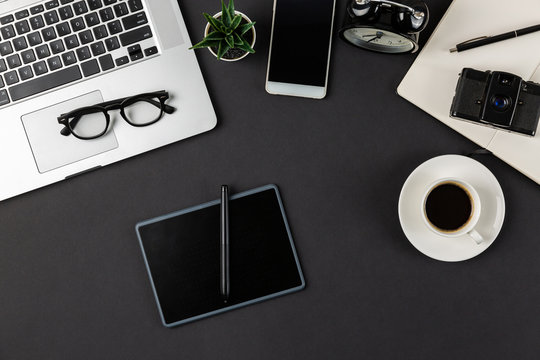 Flat lay composition of designer or digital artist workplace with graphic tablet and coffee