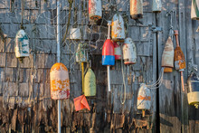 New England Weathered Wood Shack Covered With Old Lobster Trap Floats As Decorations