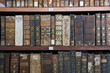 © mikesch112 - bookshelf in library with antique medieval books
