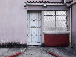 Facade of abandoned house in Guatemala City, Latin America, construction to demolish, urban area.

