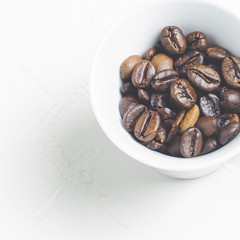 roasted coffee beans in a cup