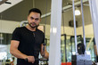 © Ranta Images - Young bearded Indian man using exercise equipment at the gym
