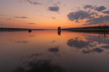 Wall Mural - charming landscape on the river at sunset and night time