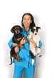 Cheerful veterinary doctor with two dogs on hands