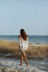 Wall Mural - Woman Walking on the Beach During Vacation