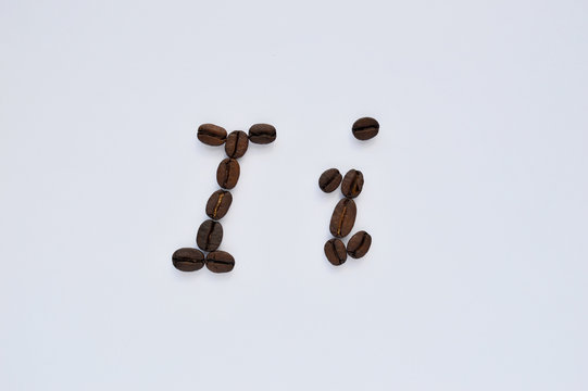 Uppercase letters i made of coffee beans on the white background