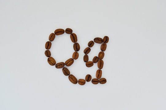 Uppercase letters q made of coffee beans on the white background