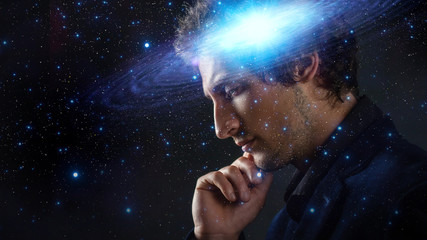 Wall Mural - thoughtful young man, creative mind concept. a man with a galaxy in his head,