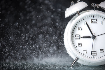 white retro alarm clock in a black background under the water drops.. Morning. Break. Motivation. Business solutions. Success. Deadline.