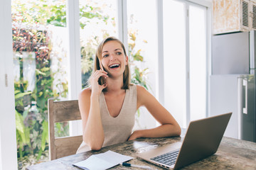 Blonde woman laughing talking on phone