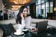 © GalakticDreamer - Happy female employee talking on phone in hotel vestibule