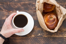 Morning Breakfast With A Cup Of Coffee And A Cinnamon Roll On A Wooden Background.