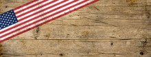 America / USA background banner panorama - Flag of united states isolated on brown dark rustic wooden wall texture, with copy space