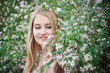 © Наталья Вагнер - Beautiful young woman posing in Azalea bushes. Blonde in pink flowers. Smiling model