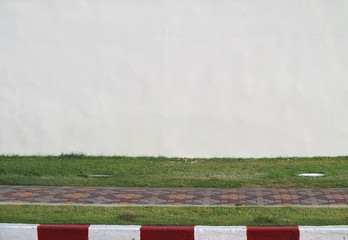 Poster - aged street white wall with grass lawn