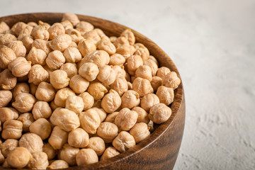 Wall Mural - Chickpeas in wooden bowl on white background.