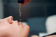 © primipil - Pipette with liquid face oil and young woman, close up portrait