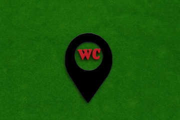 Fototapete - the letters WC on the geolocation sign on a green background. sign of the location of the hygiene room.