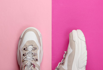 Wall Mural - Fashionable sneakers with high soles (platform) on pink background. Top view. Minimalism