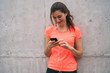 © Mego-studio - Athletic woman using her phone.